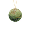 Disc Pounamu (Greenstone) pendant by Ric Moor on an adjustable cord against a white background