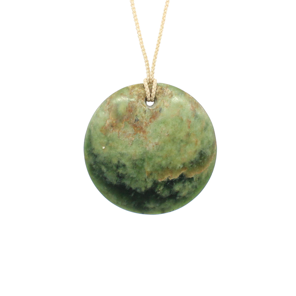 Disc Pounamu (Greenstone) pendant by Ric Moor on an adjustable cord against a white background