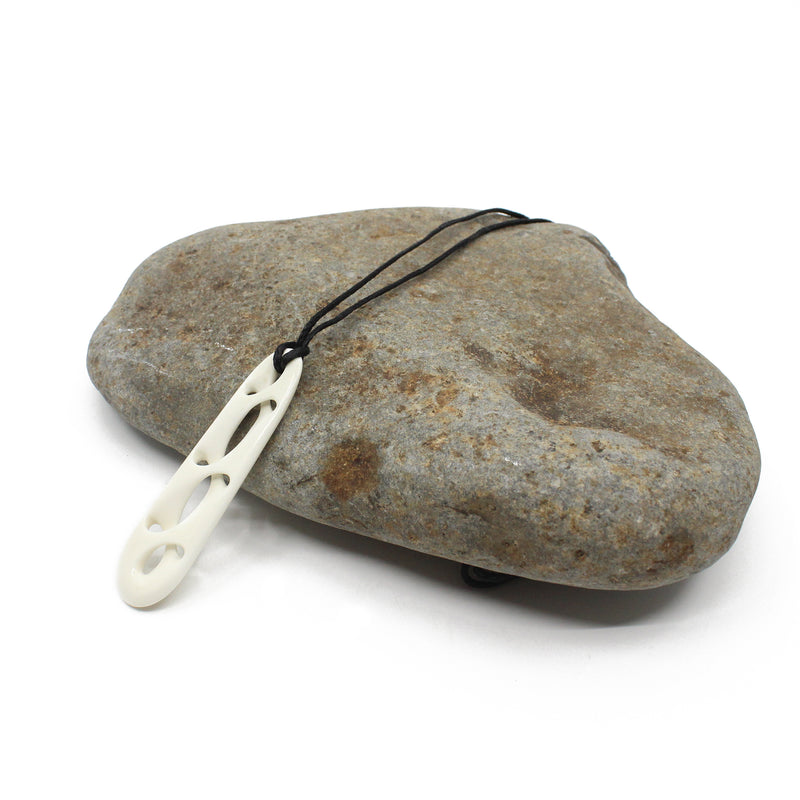Drop shape with carved multiple twists pendant carved from treated beef bone by Master carver Kerry Thompson 